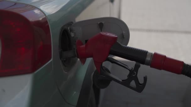 Close up of car refueling at gas station service. Open car fuel tank hatch with pump with fuel, refueling car with gasoline at gas station. Diesel pistol in car tank, car refueling. Industrial theme - Felvétel, videó