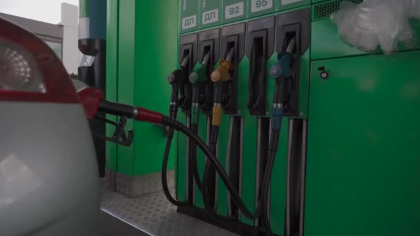 Close up of car refueling at gas station service. Open car fuel tank hatch with pump with fuel, refueling car with gasoline at gas station. Diesel pistol in car tank, car refueling. Industrial theme - Filmati, video