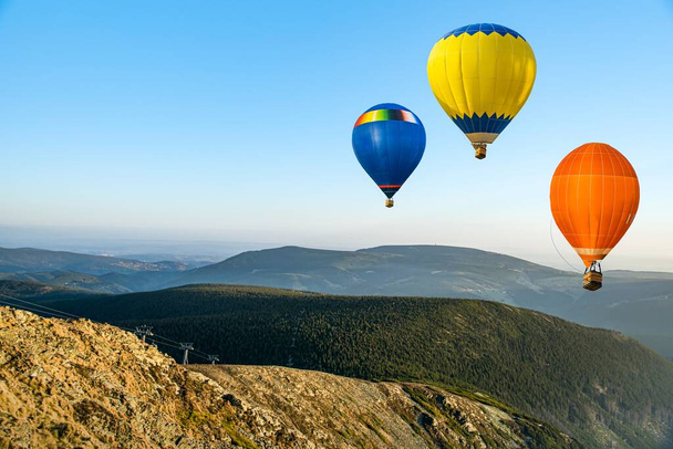 balloon soars beautifully in the air , mountains from flight altitude - Photo, Image
