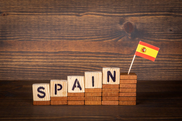 Spain. Wooden alphabet cubes on a wooden background - Photo, Image