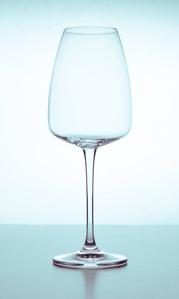 Elegant empty crystal glass for red or white wine on a white background with reflections. Glassware, bars, restaurants, beverages, lifestyle. - Foto, afbeelding