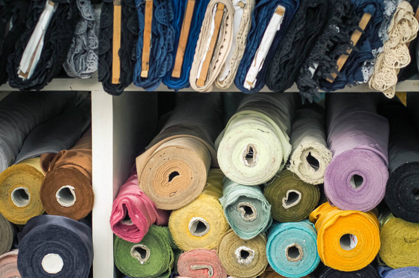 colorful fabric rolls in textile shop industry.Rolls of bright colored fabric - Foto, Imagem