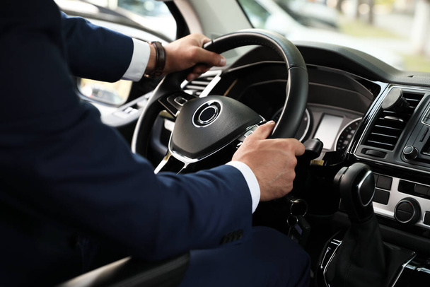 Man driving his car, closeup view of hands on steering wheel - Valokuva, kuva