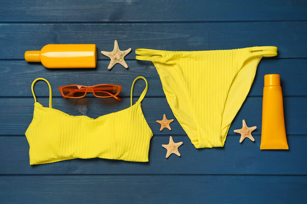 Flat lay composition with beach accessories on blue wooden background - Fotografie, Obrázek