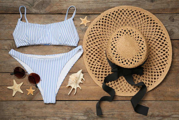 Flat lay composition with beach accessories on wooden background - 写真・画像