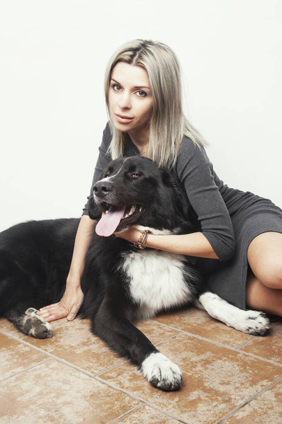 Portrait of a beautiful woman with her dog - Foto, imagen