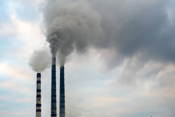 Coal power plant high pipes with black smoke moving up polluting atmosphere. - Photo, Image