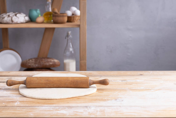 Wheat dough androlling pin for homemade bread cooking or baking on table. Food set at wooden tabletop as bakery recipe. Baking concept - Fotografie, Obrázek