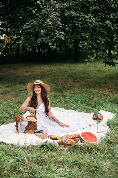 Beautiful Caucasian woman at picnic. Full length stock photo - 写真・画像