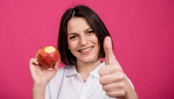 Beautiful young woman hold a big apple in her hand - Фото, зображення