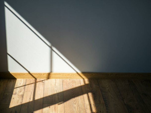 A sunny shadow falling from the window on the wall and floor of a private house - Photo, Image