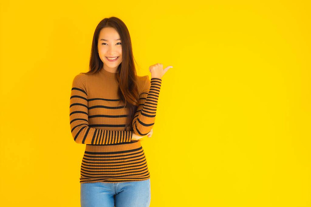 Portrait beautiful young asian adult woman smile with many action on yellow isolated background - Φωτογραφία, εικόνα