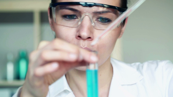 Chemist doing science experiment - Кадри, відео
