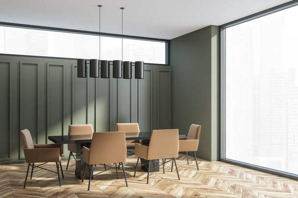 Corner of moss green meeting room with white ceiling and light brown parquet floor. Black table, dark beige chairs. Narrow window above square decorations. Chandelier. Panoramic interior. 3d rendering - Фото, изображение