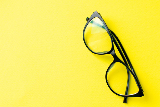 glasses for vision on a yellow background - Foto, afbeelding