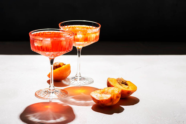 cocktail with peaches on the background - 写真・画像