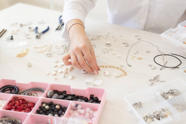 Professional jewelry designer making handmade jewelry in studio workshop close-up. Fashion, creativity and handmade concept - Fotoğraf, Görsel