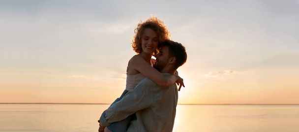 Portrait of sensual young caucasian man holding woman - Photo, image