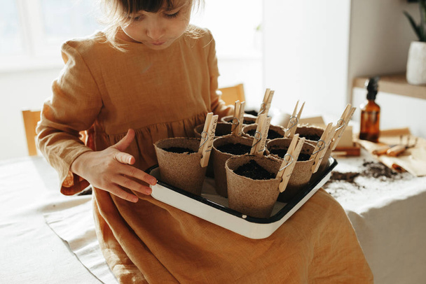 6 years old girl planting herbs at home - 写真・画像