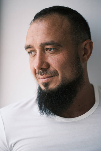 Happy muslim man with beard dressed in white t-shirt is smiling. human emotions. - Φωτογραφία, εικόνα