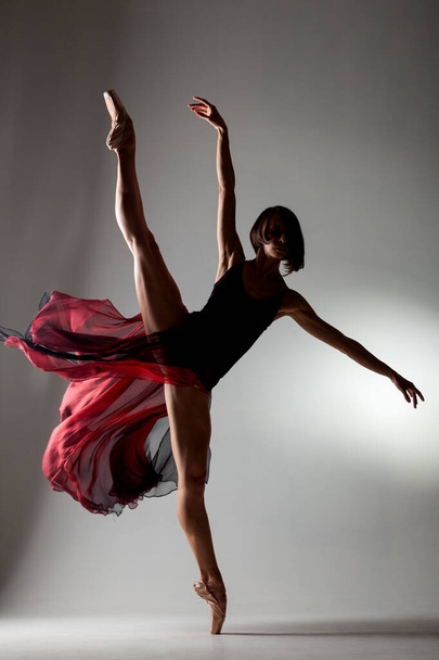 half silhouette of ballerina with a waving red dress - Φωτογραφία, εικόνα
