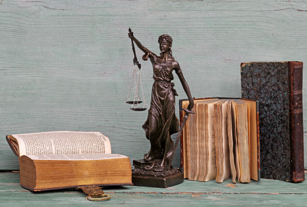 Justice figure and old books on a wooden background. Justice, scales, court - Foto, Imagem