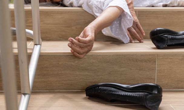 Elderly woman with walker falling down stair - Fotó, kép