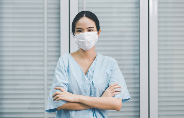 Patient woman wearing face mask protect coronavirus or covid-19 at hospital,Coronavirus protection mask - Fotó, kép