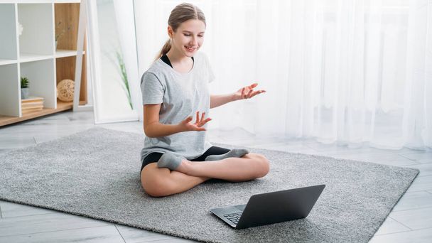 kids home yoga sport video blog girl with laptop - Φωτογραφία, εικόνα