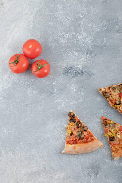 Slices of pizza with fresh red tomatoes on a white background . High quality photo - Photo, image