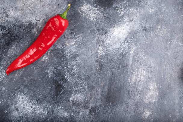 Single organic chili pepper placed on marble surface. High quality photo - Fotó, kép