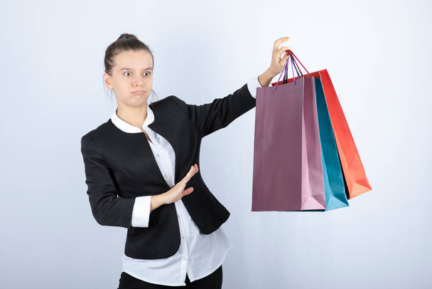 Image of young woman staying away from shopping on white background. High quality photo - Fotografie, Obrázek