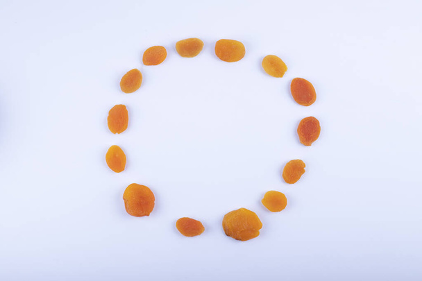 Bunch of dried organic apricots placed on white background. High quality photo - Zdjęcie, obraz