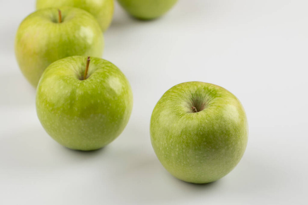 Delicious ripe green apples placed on white background. High quality photo - Fotografie, Obrázek