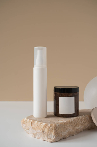 Blank spray bottle, body cream jar, marble stone on neutral pastel beige background. Aesthetic minimal beauty cosmetics composition with body care treatment. Organic natural spa therapy product - Photo, Image