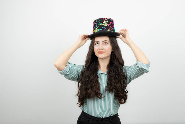 Portrait of young woman with long hair wearing magician hat . High quality photo - Foto, imagen