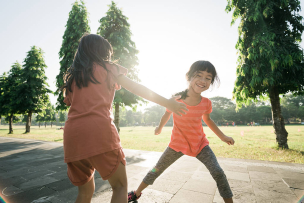 kid catch and play together outdoor with friend - Foto, Imagen