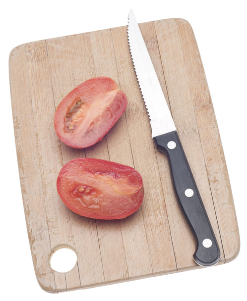 Sliced Roma Tomato on a Wooden Chopping Block Isolated on White with a Clipping Path. - Photo, Image