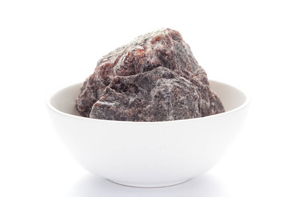Close-up of coarse Himalayan Black  Salt (sodium chloride) edible on white ceramic bowl. - Photo, Image