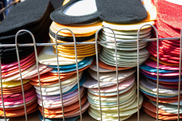 A closeup shot of colorful socks sold in a market - Fotó, kép