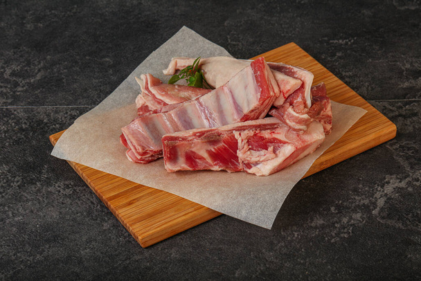 Raw lamb ribs served rosemary for cooking - Photo, image