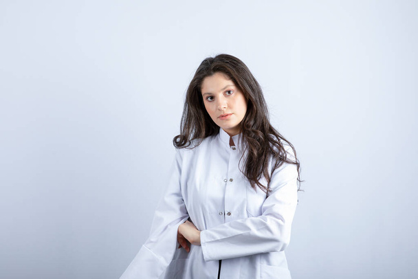 Photo of young doctor posing and standing on white background. High quality photo - Foto, Imagen