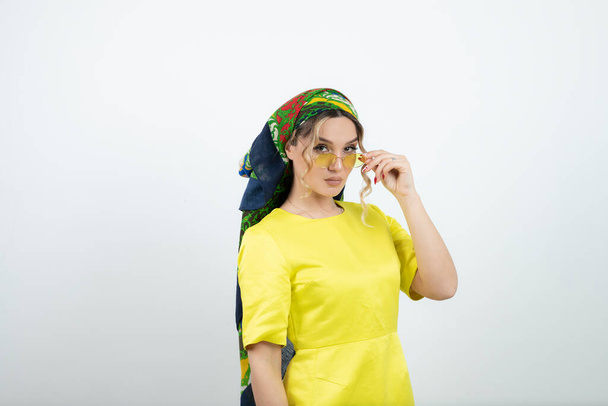 Picture of beautiful woman in headkerchief posing in glasses . High quality photo - Fotó, kép