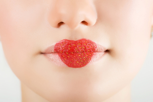 Heart on stawberry lips of pretty woman closeup - Photo, Image