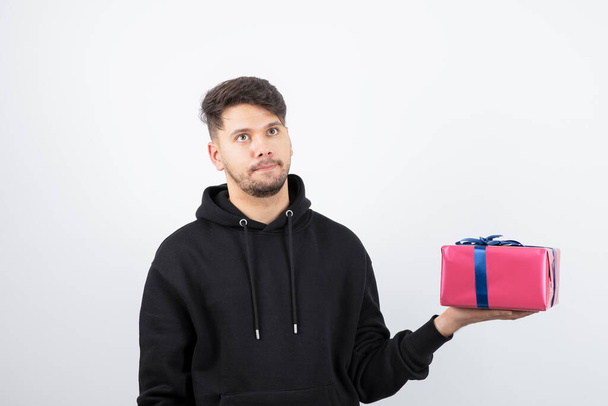 Portrait of an attractive man holding present box . High quality photo - Foto, imagen