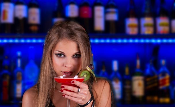 Girl with cocktail on dancing background - Foto, Imagen