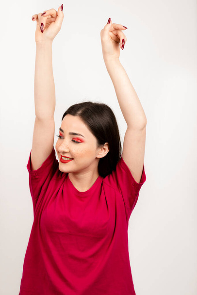 Pretty woman with beautiful make-up raising hands . High quality photo - Foto, afbeelding
