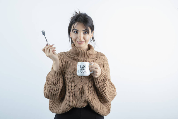 Portrait of young woman holding cup of coffee on white background. High quality photo - Valokuva, kuva