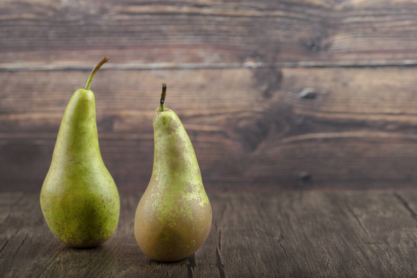 Two ripe delicious green pears on wooden background. High quality photo - Photo, Image