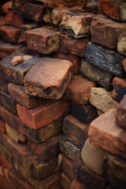 stack of antique earthen red-black bricks background. - Photo, Image